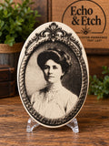 Vintage woman oval wood plaque with laser-engraved Edwardian portrait and ornate baroque border on natural wood grain.
