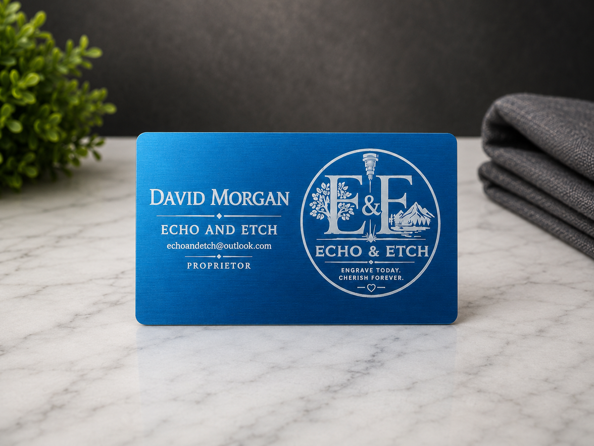 Vibrant blue custom anodized aluminum business card with silver laser engraving and circular Echo and Etch logo