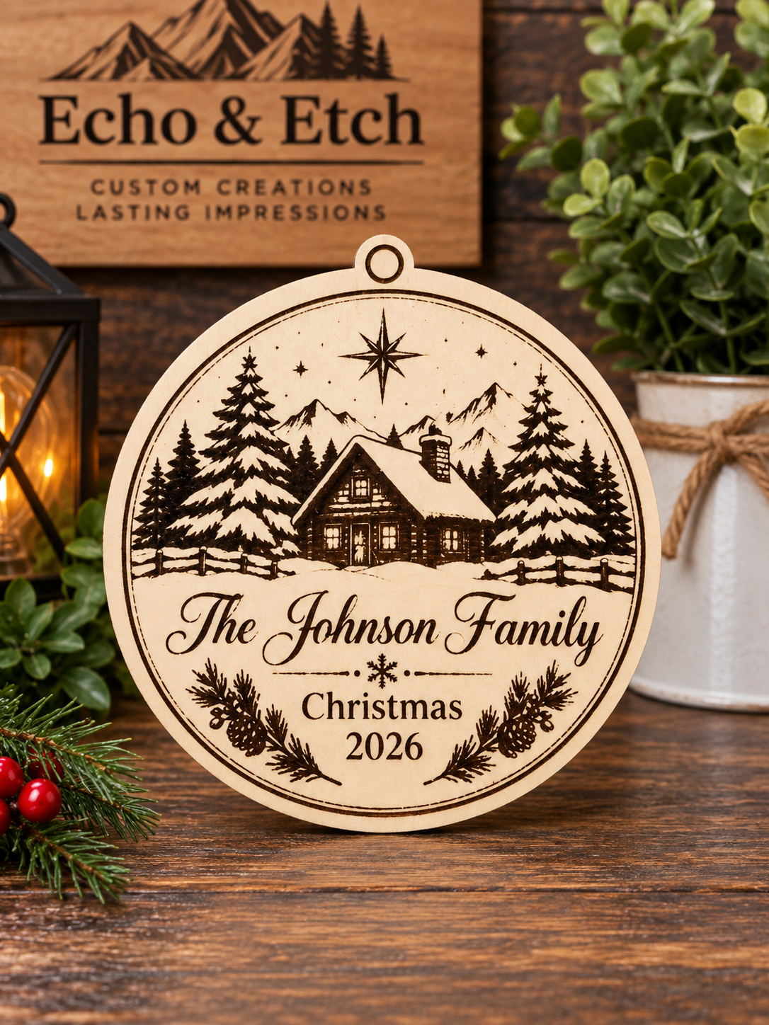 Custom laser-engraved wooden family cabin Christmas ornament with winter scene, pine accents, and personalized name and year