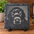 Photorealistic laser engraved dog face on rustic dark slate pet portrait plaque with black stand